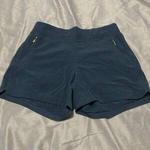 navy blue athletic shorts with rose gold zipper